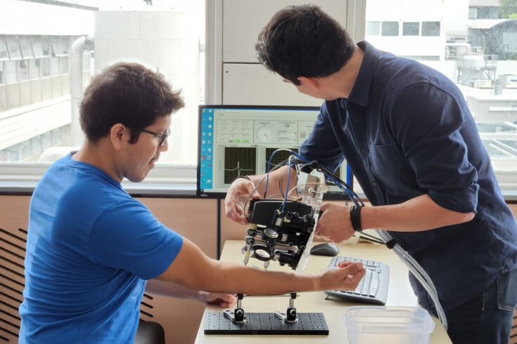 Researchers testing the skinometer on patient