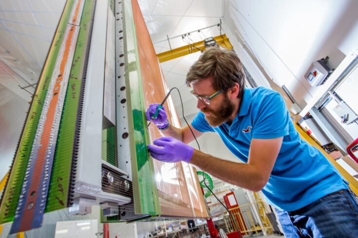 A technician soldering 1 of the thousands of solder points on an APA at Daresbury Laboratory