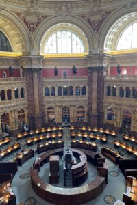 The main reading room at the Library of Congress, a high-ceilinged space with reading desks set up in the round.