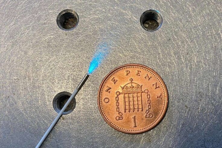 Endoscope fibre next to a penny for scale