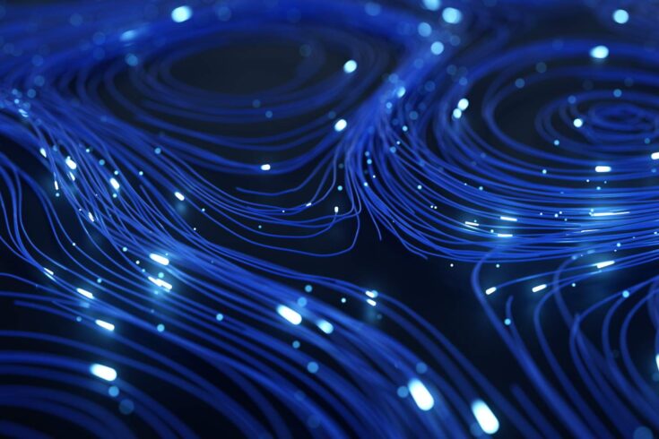 Abstract background of blue lines and glowing particles.