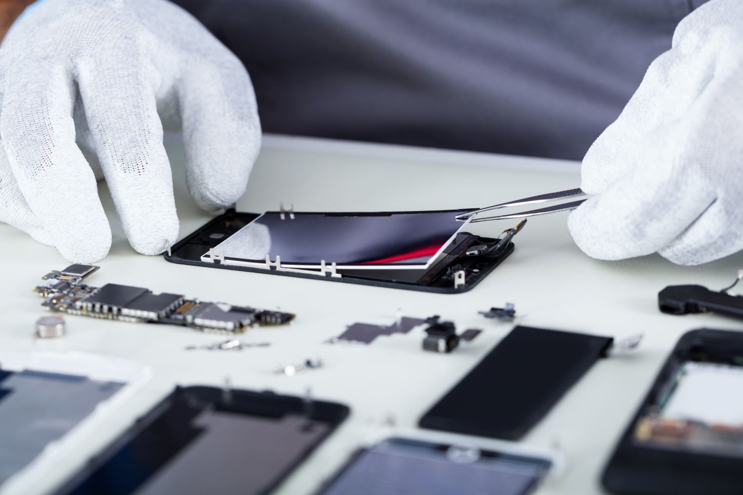 Disassembling a smartphone with tweezers