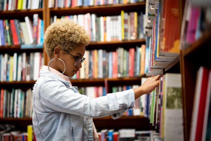 Student Choosing a book in a library