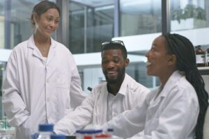 Shot of a group of scientists smiling at each other in a lab