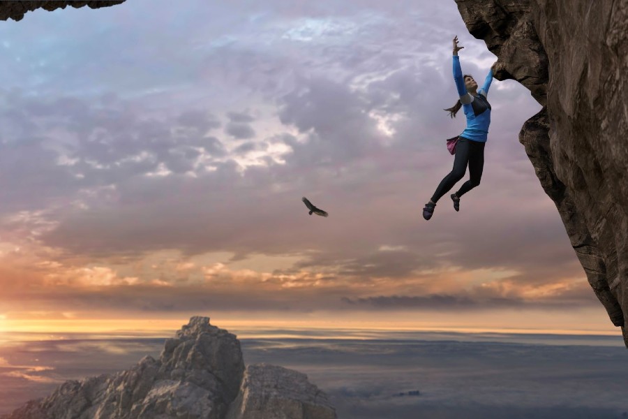 Rock climber free climbing rock face