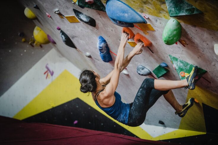 Woman climbing an indoor climbing wall