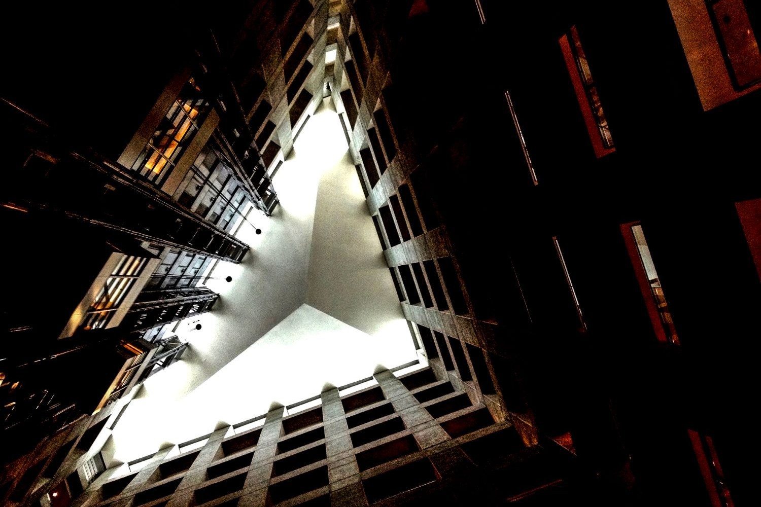 Looking up through a triangular building courtyard