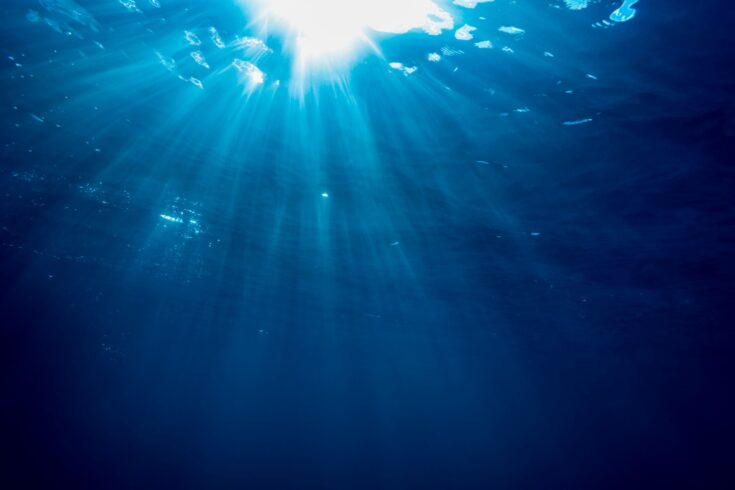 Rays of light cross the waterline in a tropical beach