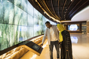 Side view of an adult couple enjoying interactive learning experience in UNESCO World Heritage Site near Riyadh.