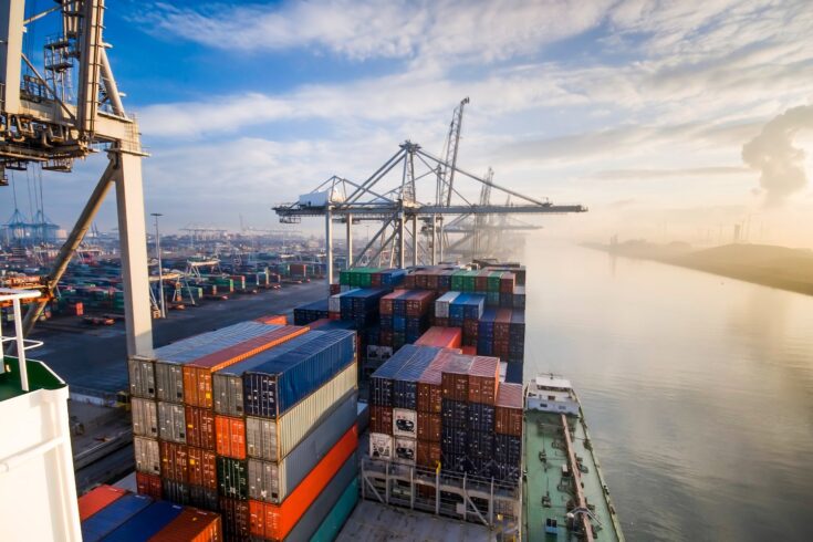 Sunrise in busy shipping container terminal in Rotterdam, Netherlands