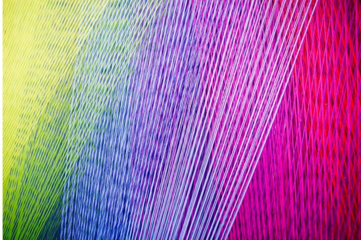 Strands of colorful yarn on a Loom