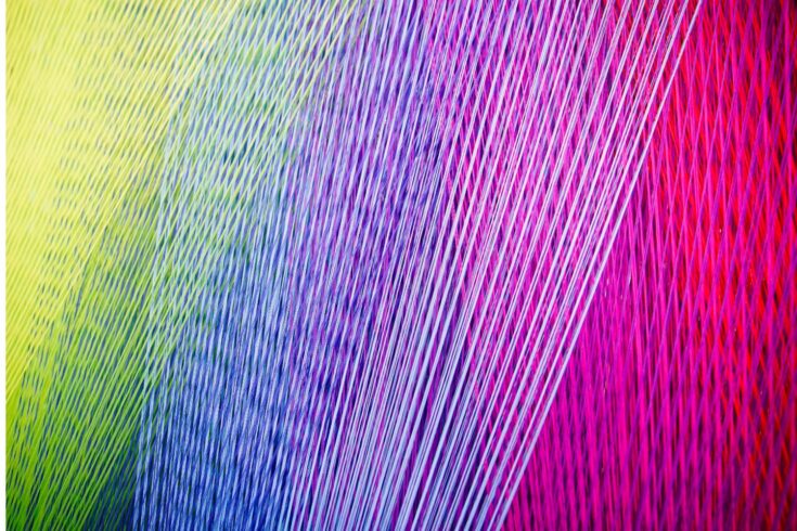 Strands of colorful yarn on a Loom