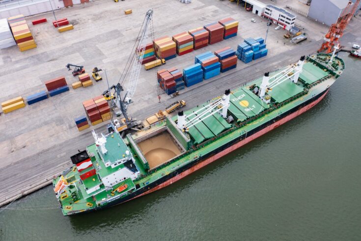 Cargo ship being filled with grain for transport