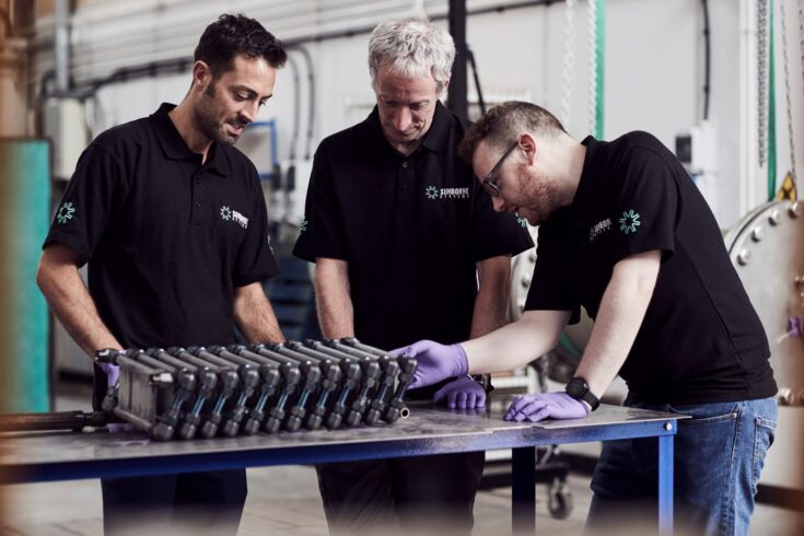 Three technicians with hydrogen fuel cell