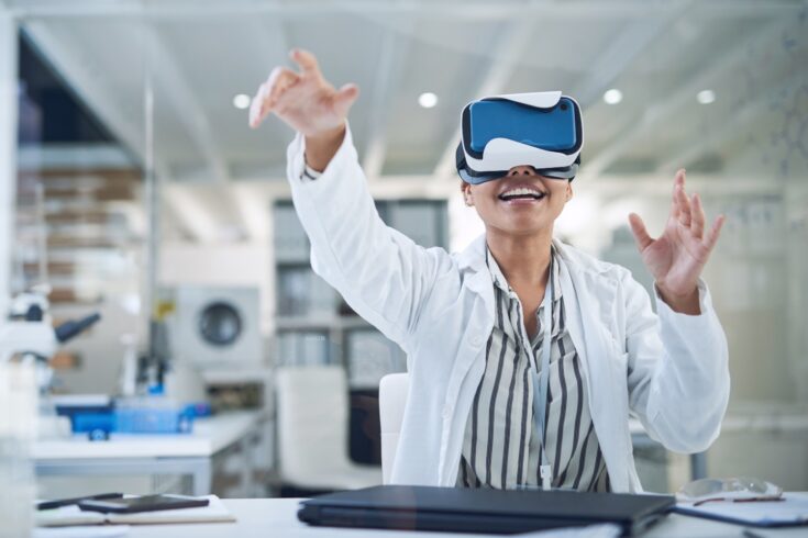 Shot of a young scientist using a virtual reality headset while working in a lab