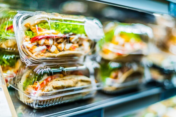 Chicken with pita, pre-packaged sandwiches displayed in a commercial refrigerator