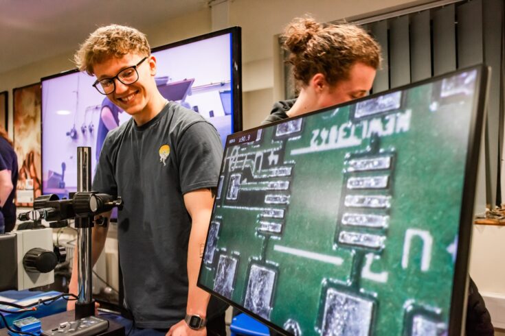 Apprentice wearing a grey t-shirt displaying a motherboard and recent technological engineering completed.
