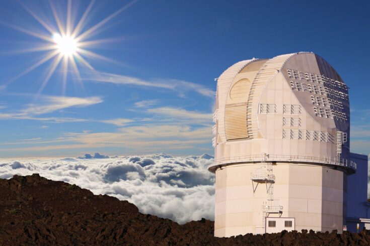 Large structure with curved roof on mountain above clouds