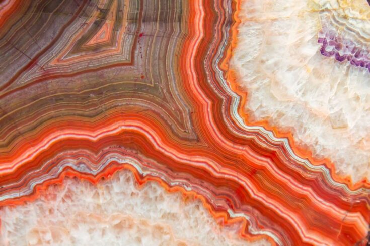 A close up image of a red agate mineral