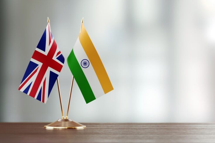 Small UK and India flags sat on a desk