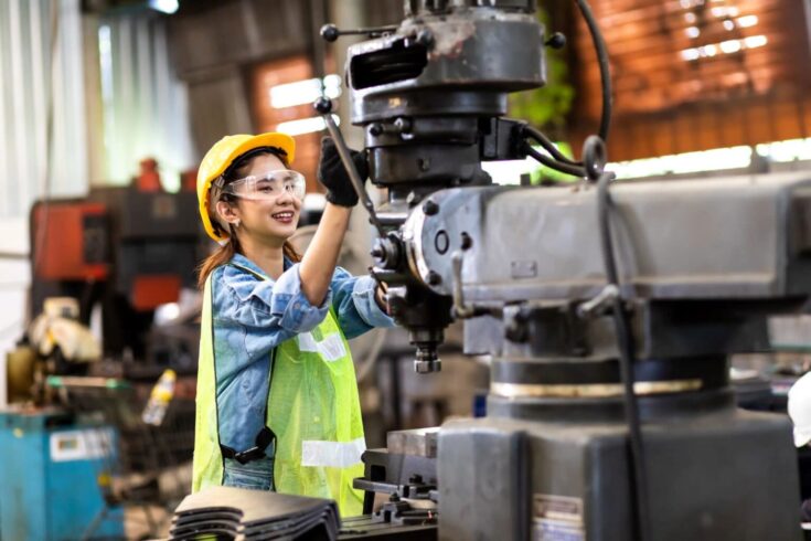: Female engineer operating heavy machinery.
