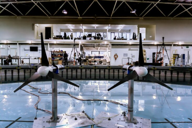 Two small turbines floating on a pool in a lab.