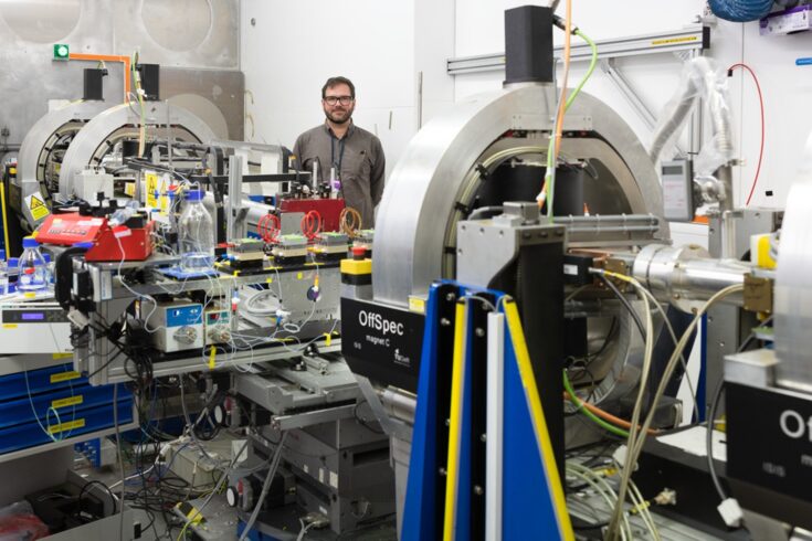 Man stood in laboratory with large lab equipment