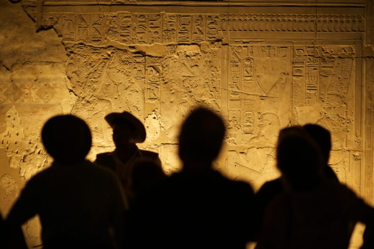 Egyptian hieroglyphs with silhouettes of people