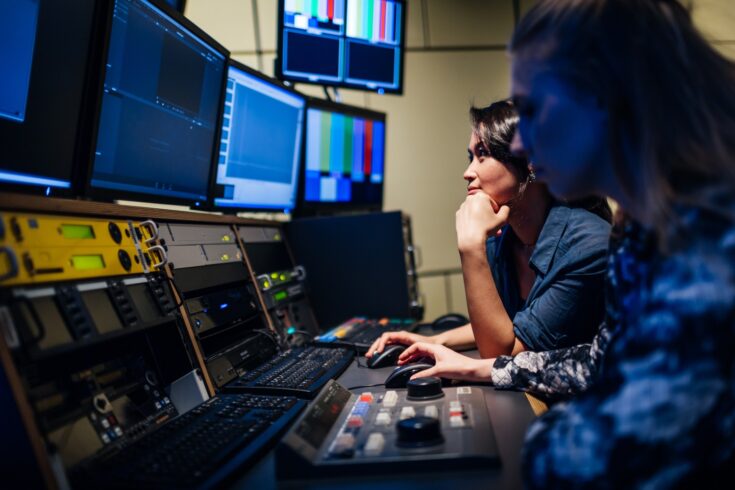 Two university students experimenting with video software and hardware during class