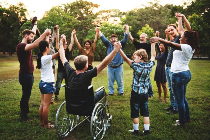 Group of people holding hand together in the park