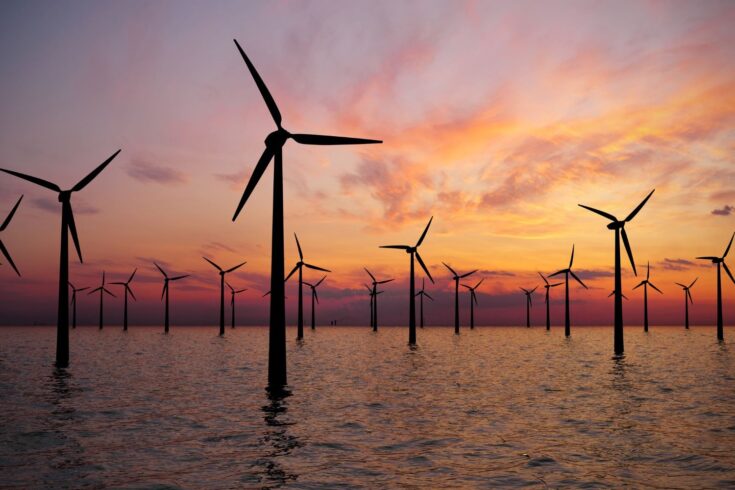 Offshore wind turbines farm at sunset