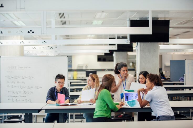 A laboratory classroom with a group of female science students working.