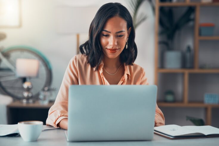 Woman working on laptop online