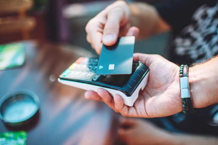 Close up of someone using contactless to pay