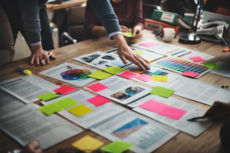 Document pages laid out on table with post it notes