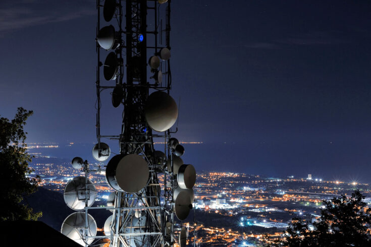 Telecommunications tower, antenna and satellite. Cellular station for smart city connect, aerial view.