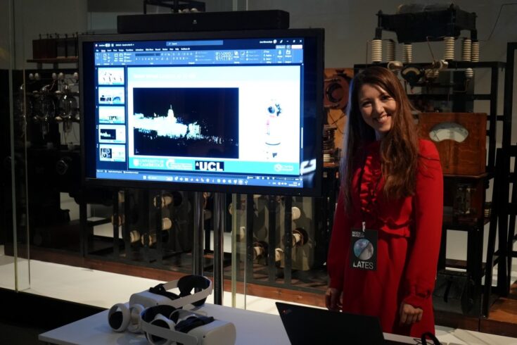 A woman smiling next to a screen showing LiDAR data