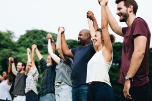 Happy diverse group holding hands