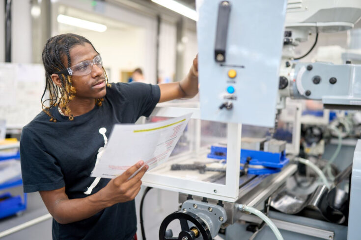 Engineering student working on equipment.