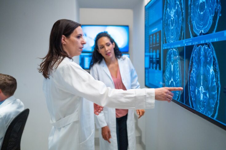 Two radiologists looking at MRI scans