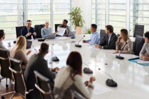 Colleagues sat around a large table at a board meeting