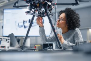 Female engineer working on a drone in a laboratory.