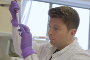 Team member and co-author of the paper Dr Sam Lockhart at work in the lab.