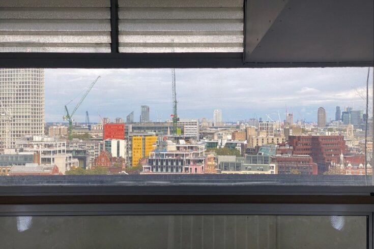 View of the London skyline from a window.