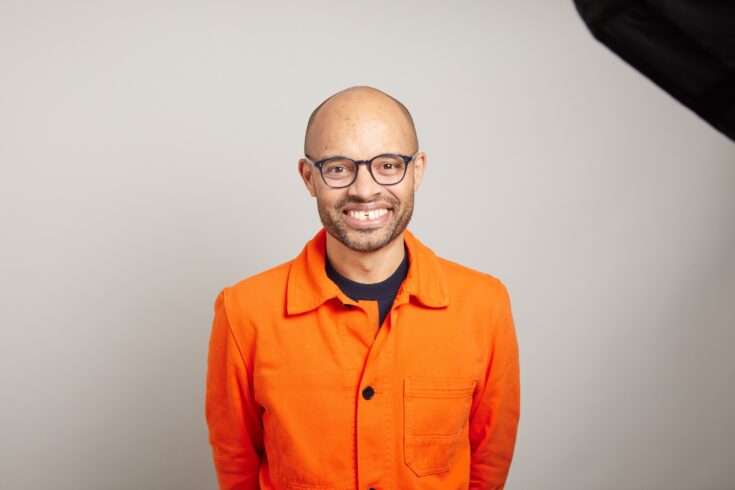 A headshot of Tom Adeyoola.