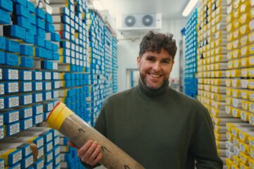 Man holding sediment sample in sediment storage facility.