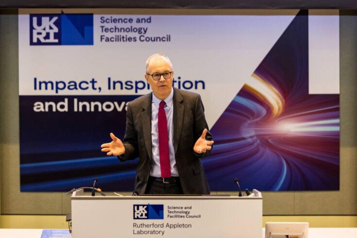 A person in a suit talking on a podium