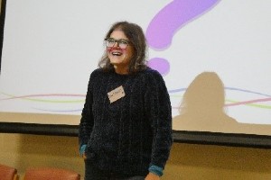 A woman stood in front of a large screen.