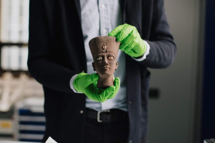 Dr Martin Odler holding an Egyptian artefact.