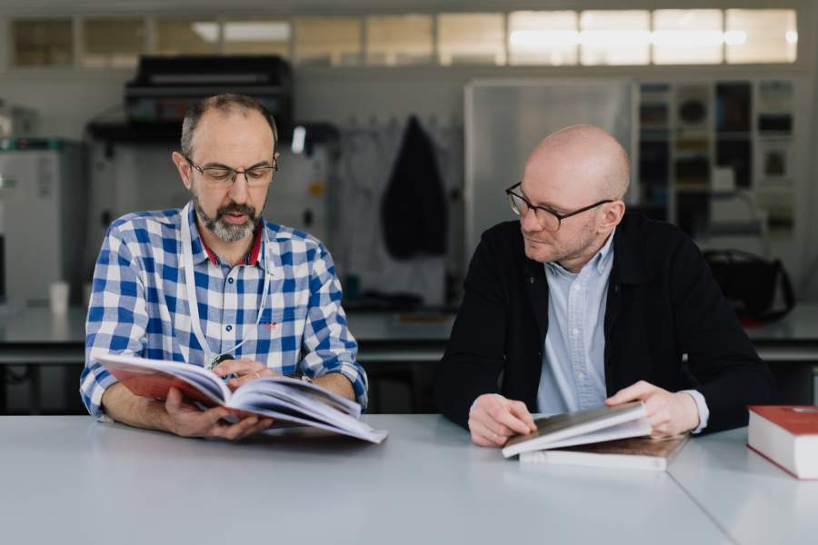 Professor Andrea Dolfini and Dr Martin Odler sat together with open books.